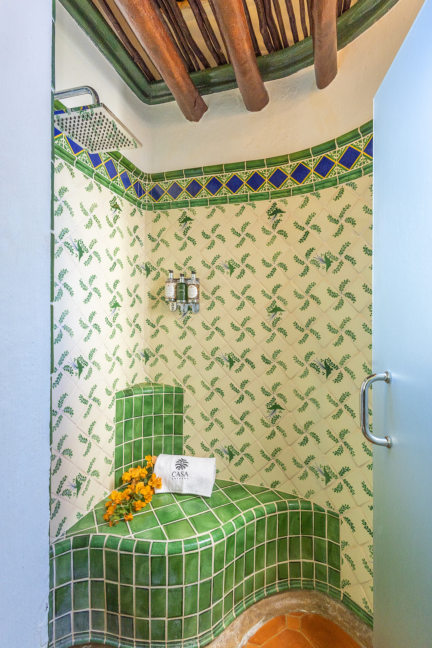 Inviting pool terrace just steps away from the Queen Room, surrounded by palm trees and sun loungers for ultimate relaxatio