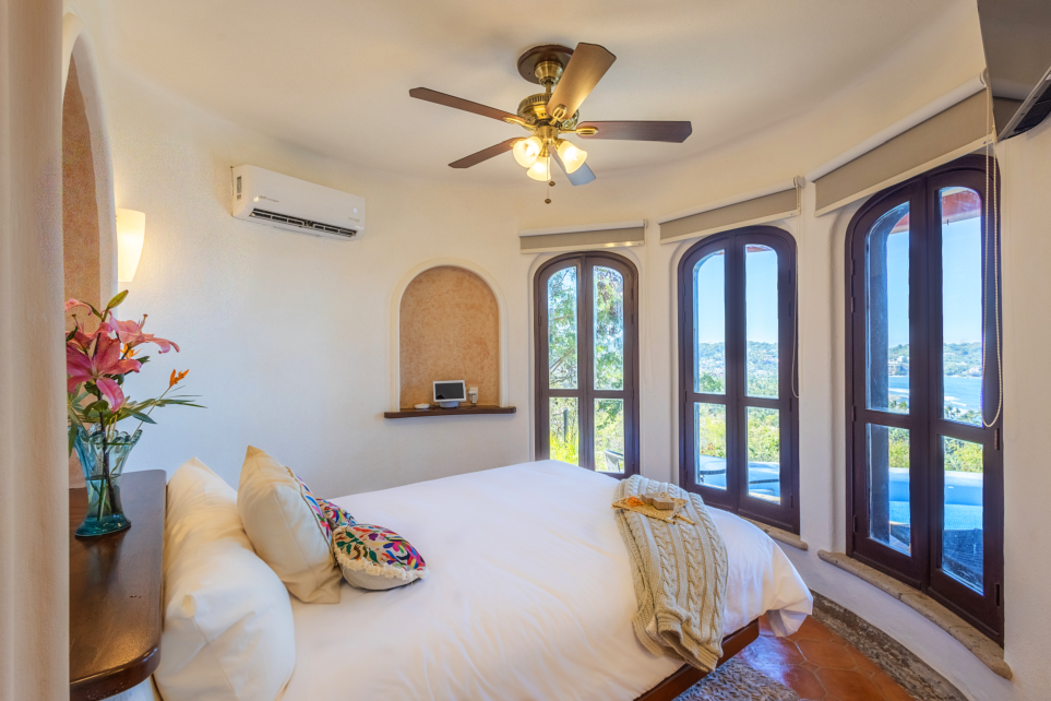 Elegant en-suite bathroom with modern fixtures and tropical-inspired design, providing a luxurious experience for guests."  Image 6: "Inviting pool terrace just steps away from the Queen Room, surrounded by palm trees and sun loungers for ultimate relaxation."  Feel free to modify any of these descriptions as needed!  