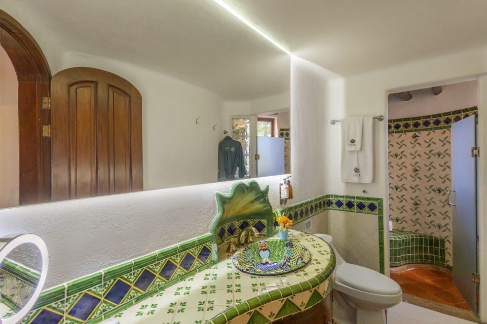 Elegant en-suite bathroom with modern fixtures and tropical-inspired design, providing a luxurious experience for guests