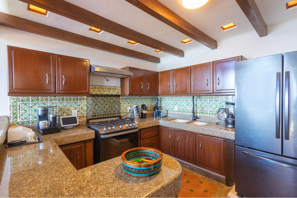 Chef preparing a meal in the fully equipped kitchen, showcasing culinary creativity.