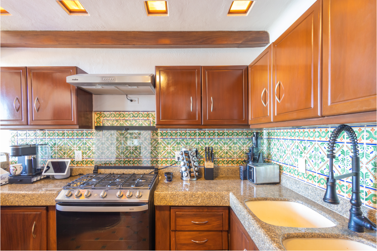 Bright dining area featuring a large table set for a meal with stunning ocean scenery